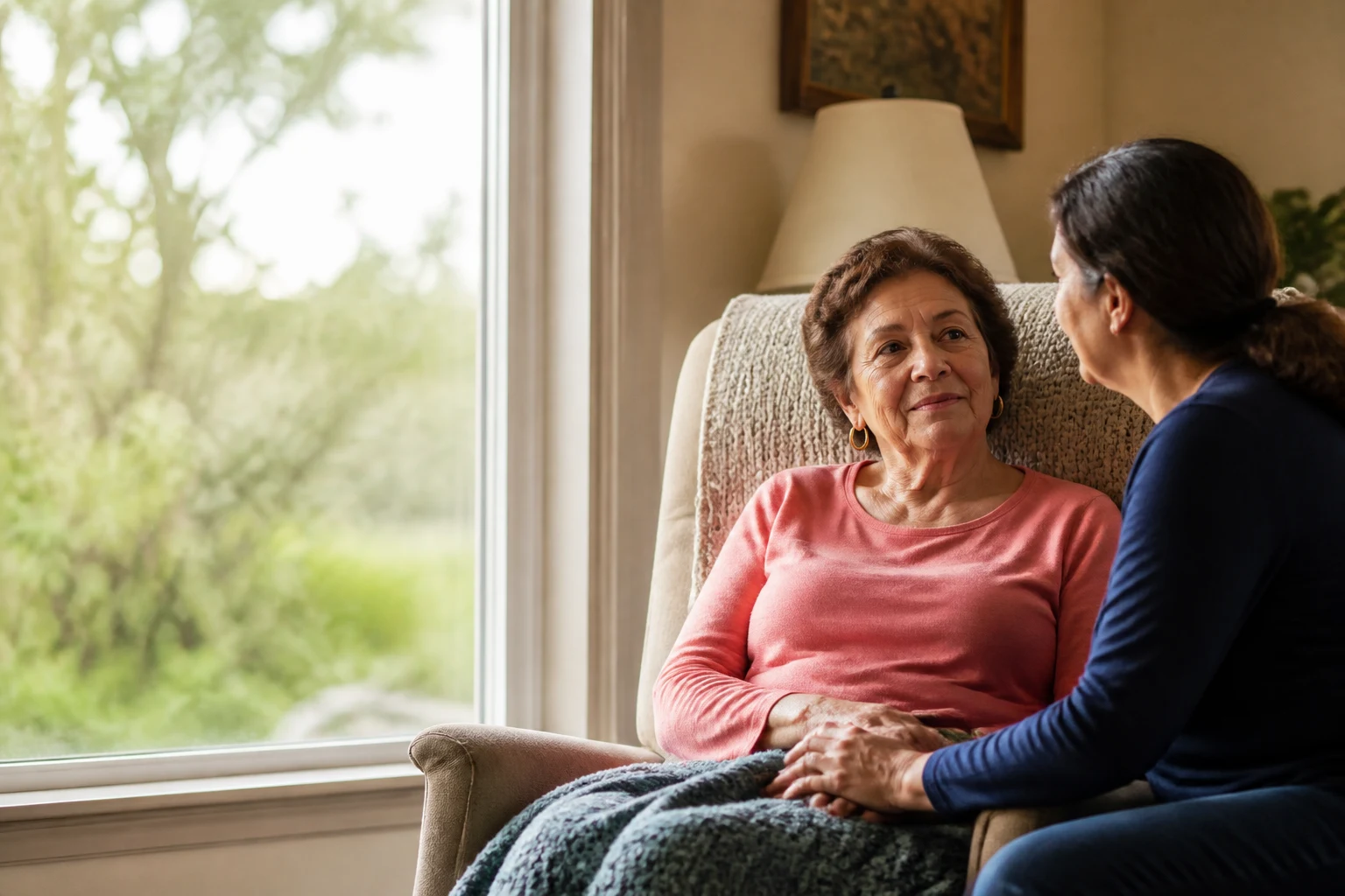 Family caregiver sharing a quiet supportive moment with an older adult at home